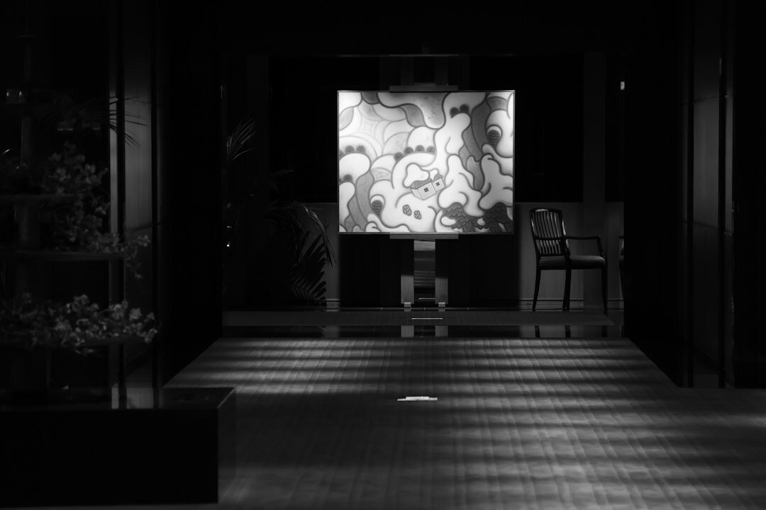 Wide shot of an empty modern television studio floor with lighting grid above