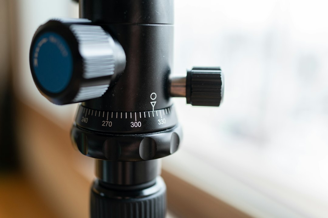 Professional broadcast camera lens close up on a tripod
