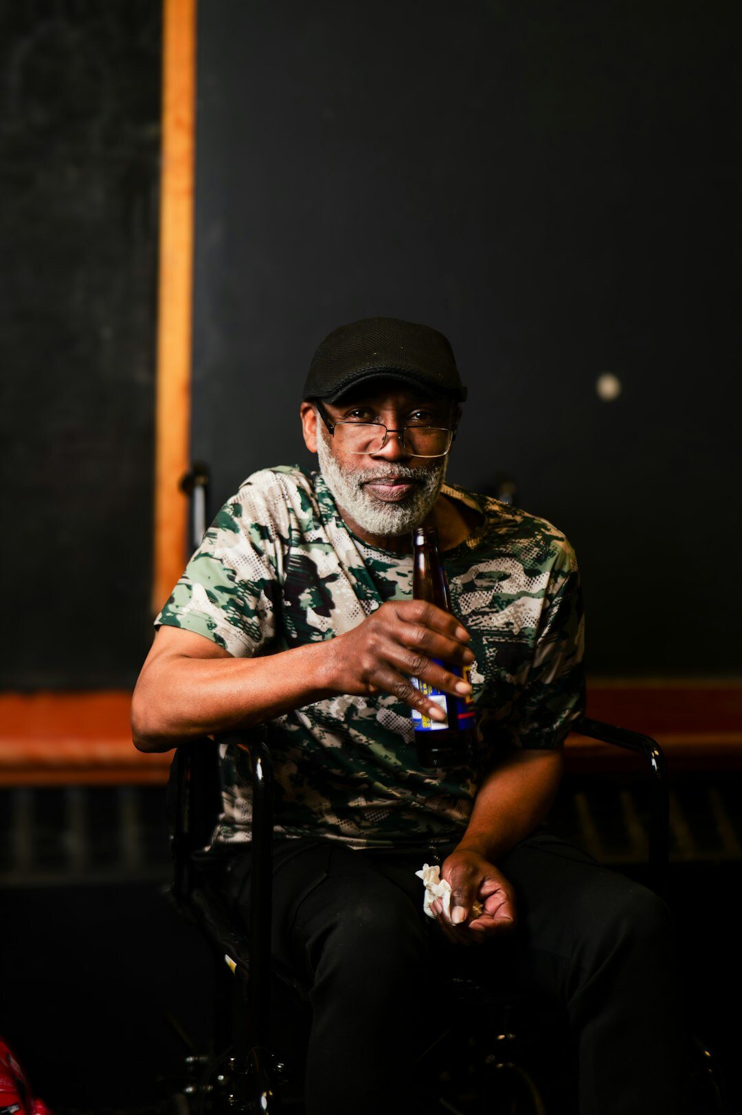 Portrait of a senior male studio director with grey hair and glasses