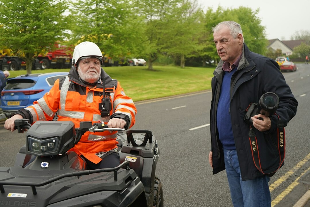 Trainer showing a trainee how to operate a broadcast camera
