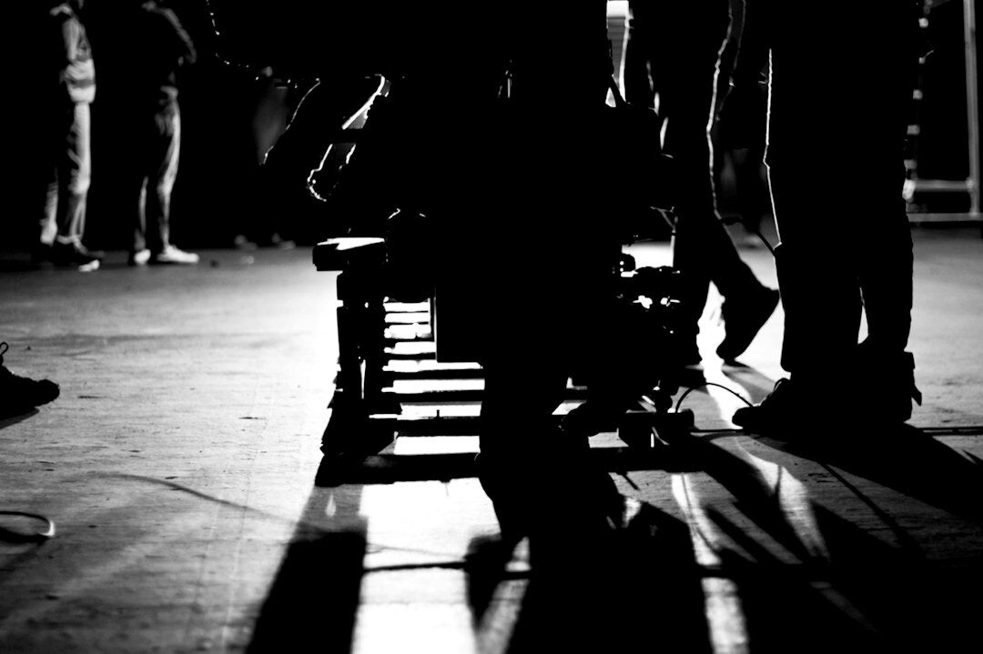 Camera operator tracking a shot on a studio dolly